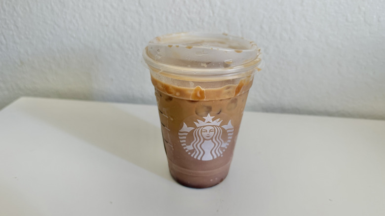 Iced Caramel Hazelnut Mocha Macchiato in a plastic cup