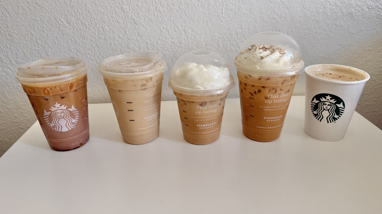 Five drinks lined up on a table