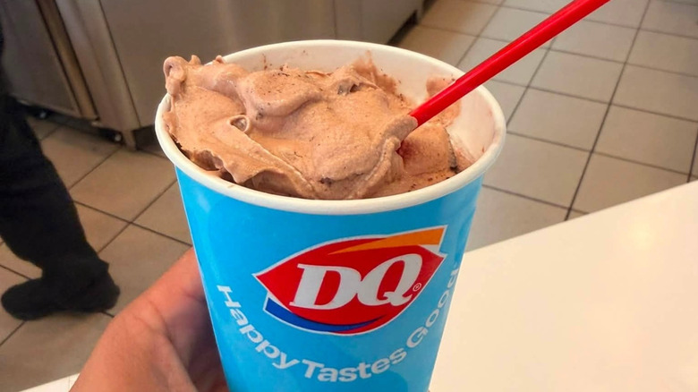 Person holding a chocolate Blizzard from Dairy Queen