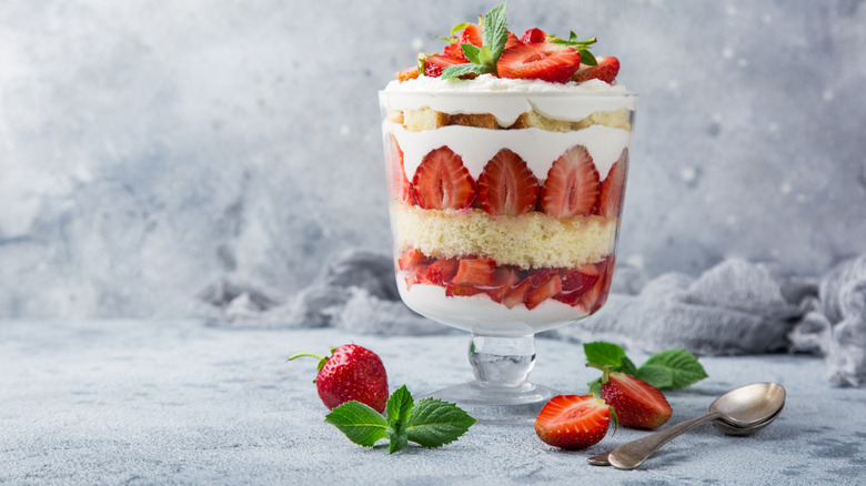 A layered strawberry trifle in a glass