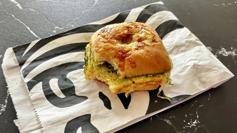 Starbucks' Egg, Pesto & Mozzarella Sandwich with one bite taken out of it.