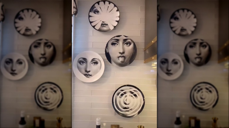 Plates hanging on tiled kitchen wall