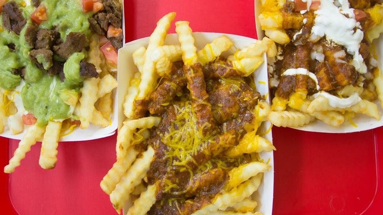 Del Taco Chili Cheddar Fries on red surface