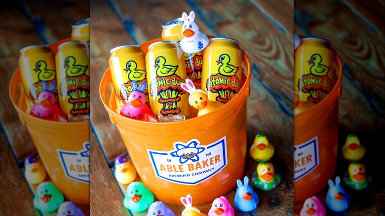 Several cans of Atomic Duck in a bucket