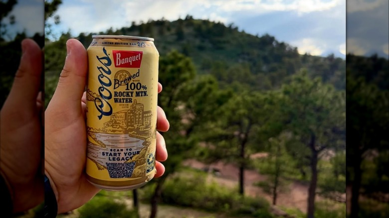 Hand holding a can of Coors Banquet