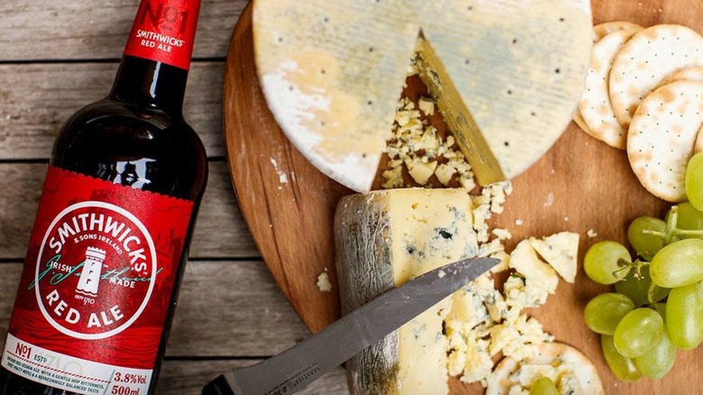 Bottle of Smithwick's Red Ale alongside cheese and grapes