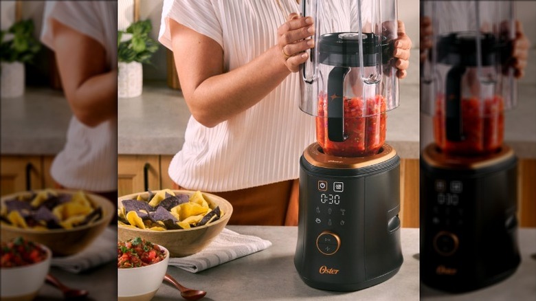 A woman placing the noise shield over the Oster QuietPro blender