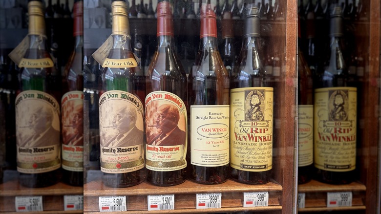 Bottles of Pappy Van Winkle in a display case with high price tags listed underneath