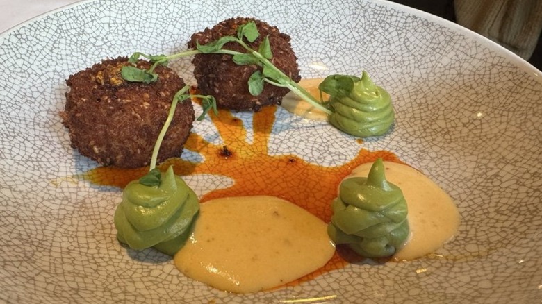 Crab cakes with greens and several different sauces