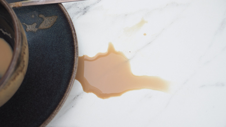 Coffee spilled on a white marble counter