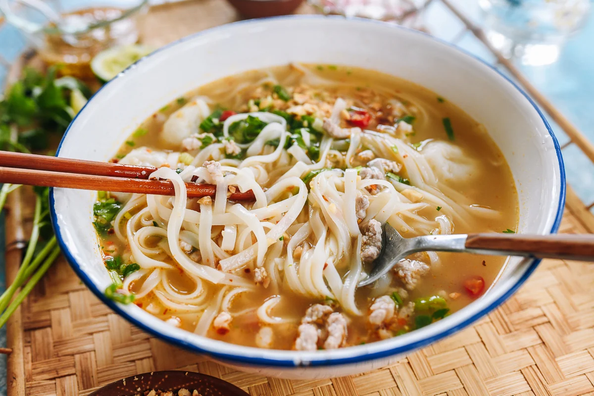 mixing tom yum noodle soup