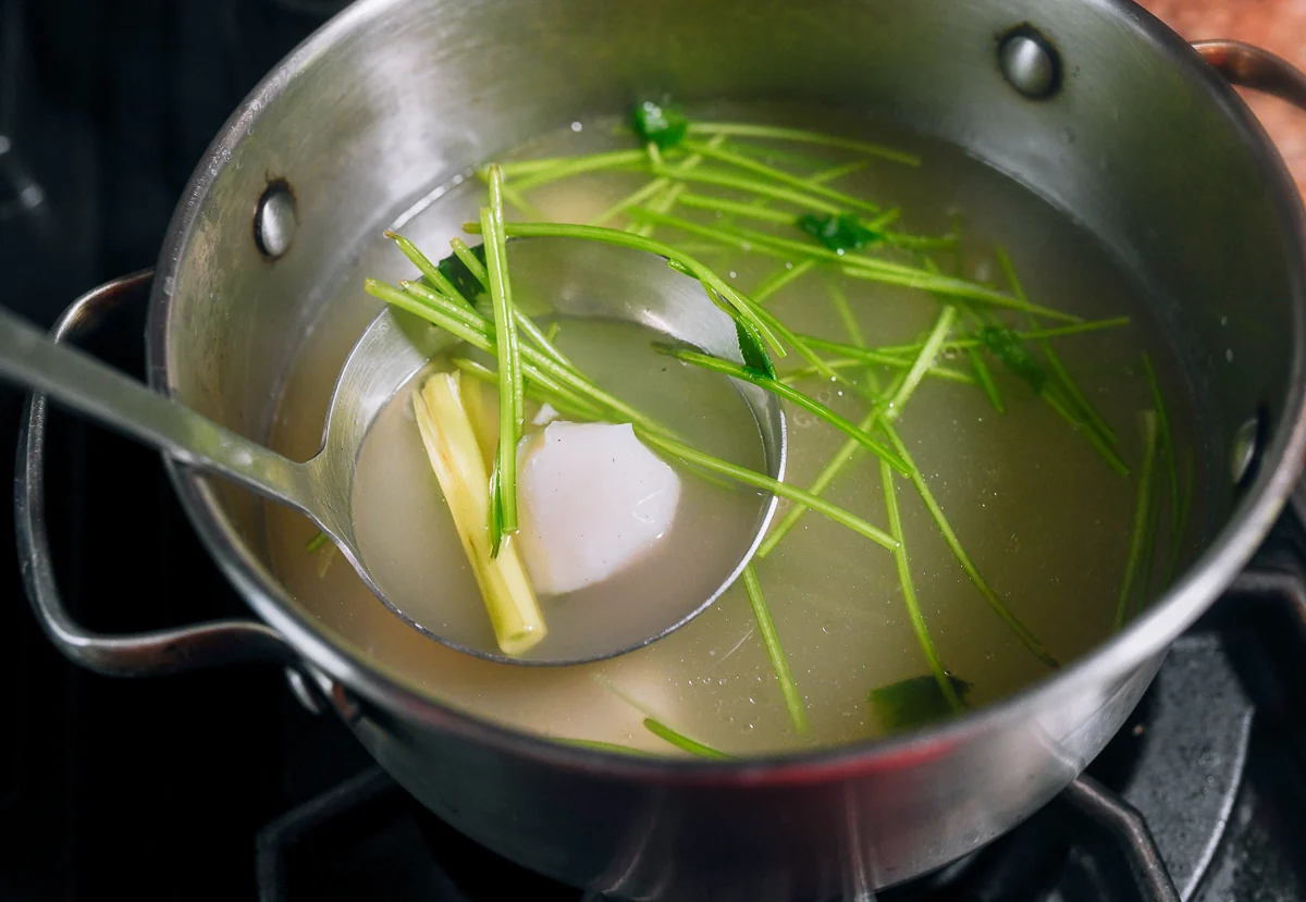 lemongrass, fish ball, and cilantro stems in broth