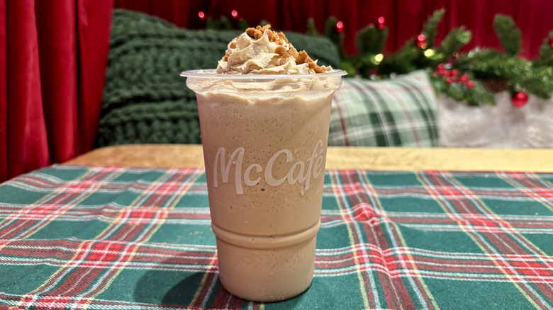 Small McDonald's Cookie Butter Frappé on table with holiday decorations