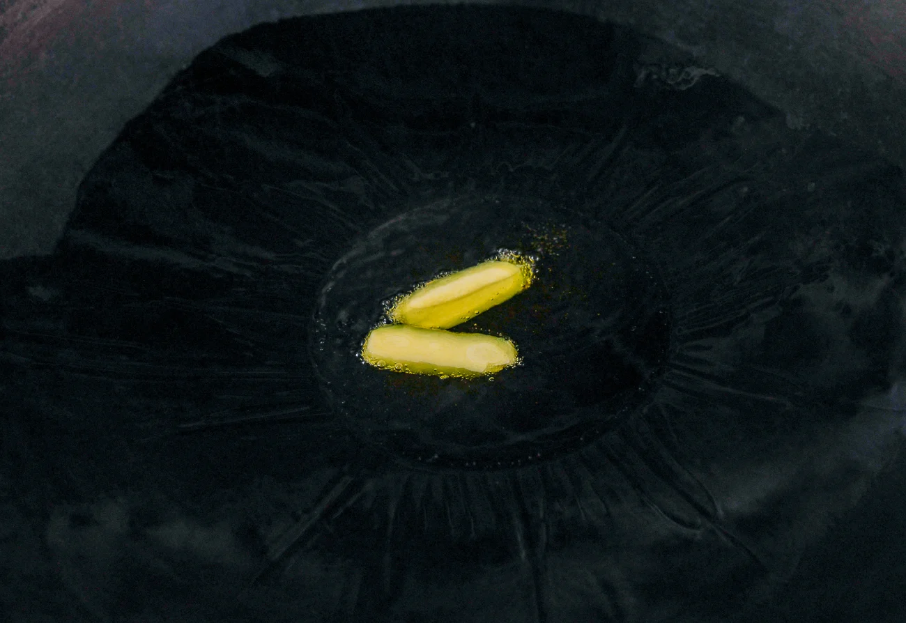 ginger slices in oil in wok