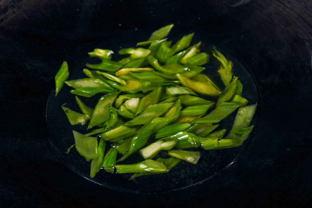 stir-fried mustard green stems in wok