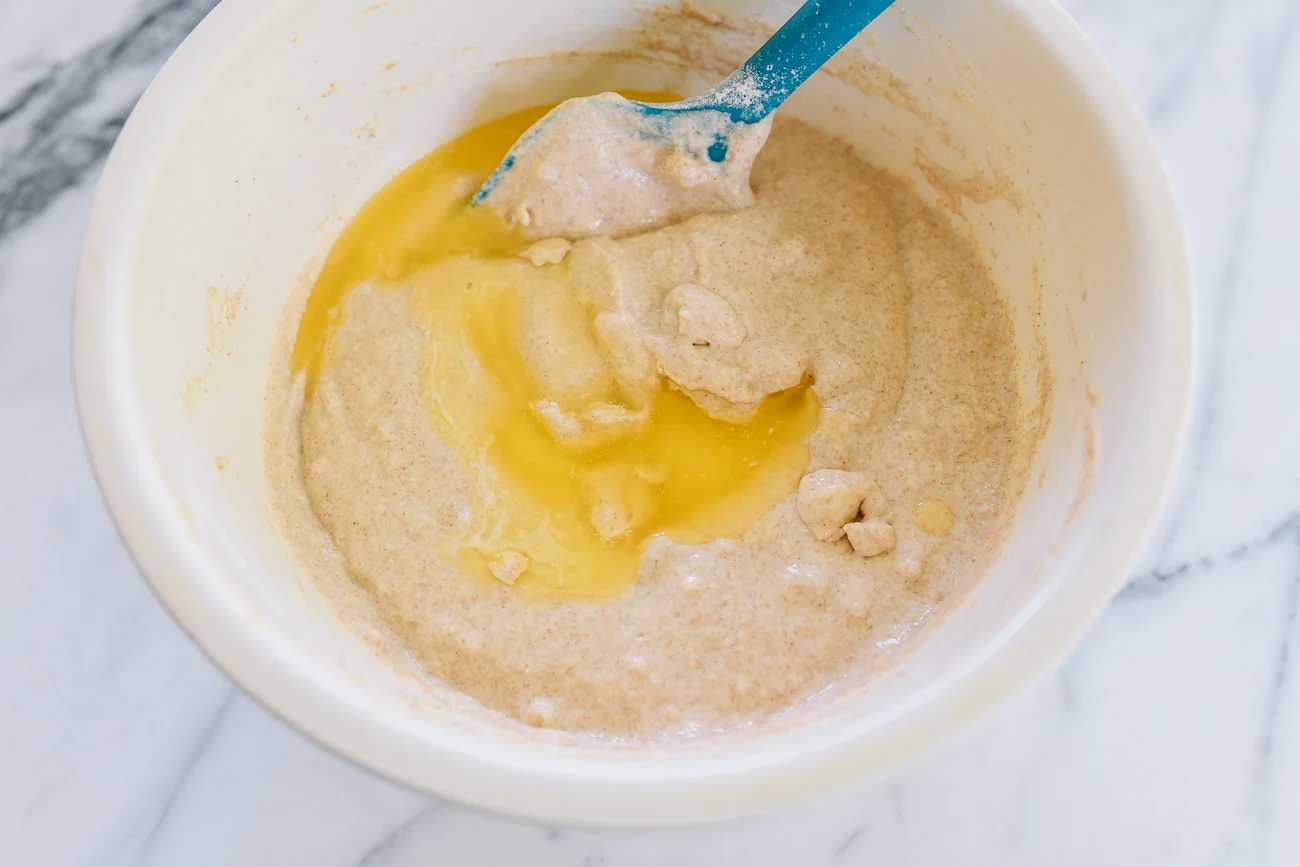 mixing melted butter into whole wheat pancake batter