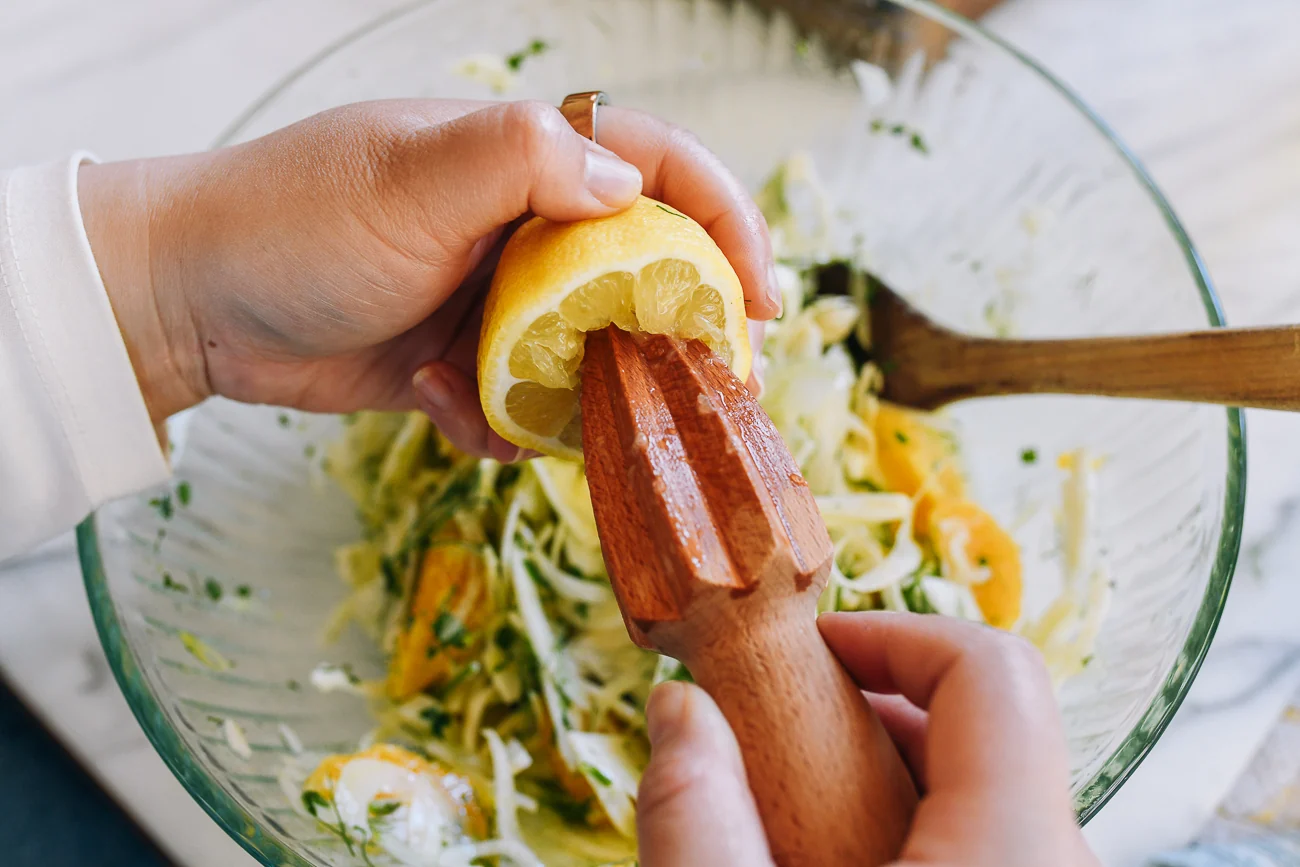 squeezing lemon juice into salad