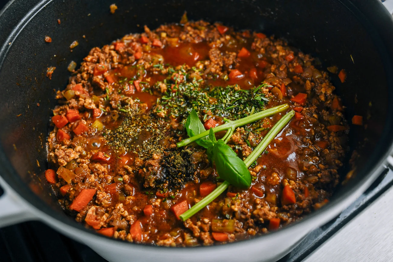 basil stems added to meat sauce mixture