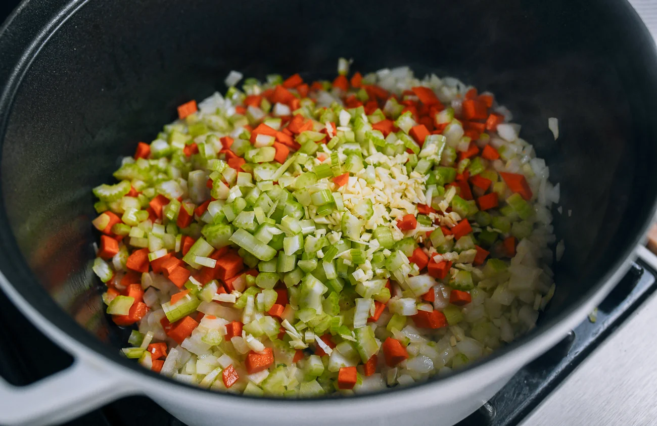 cooking onion, carrot, celery, and garlic in dutch oven