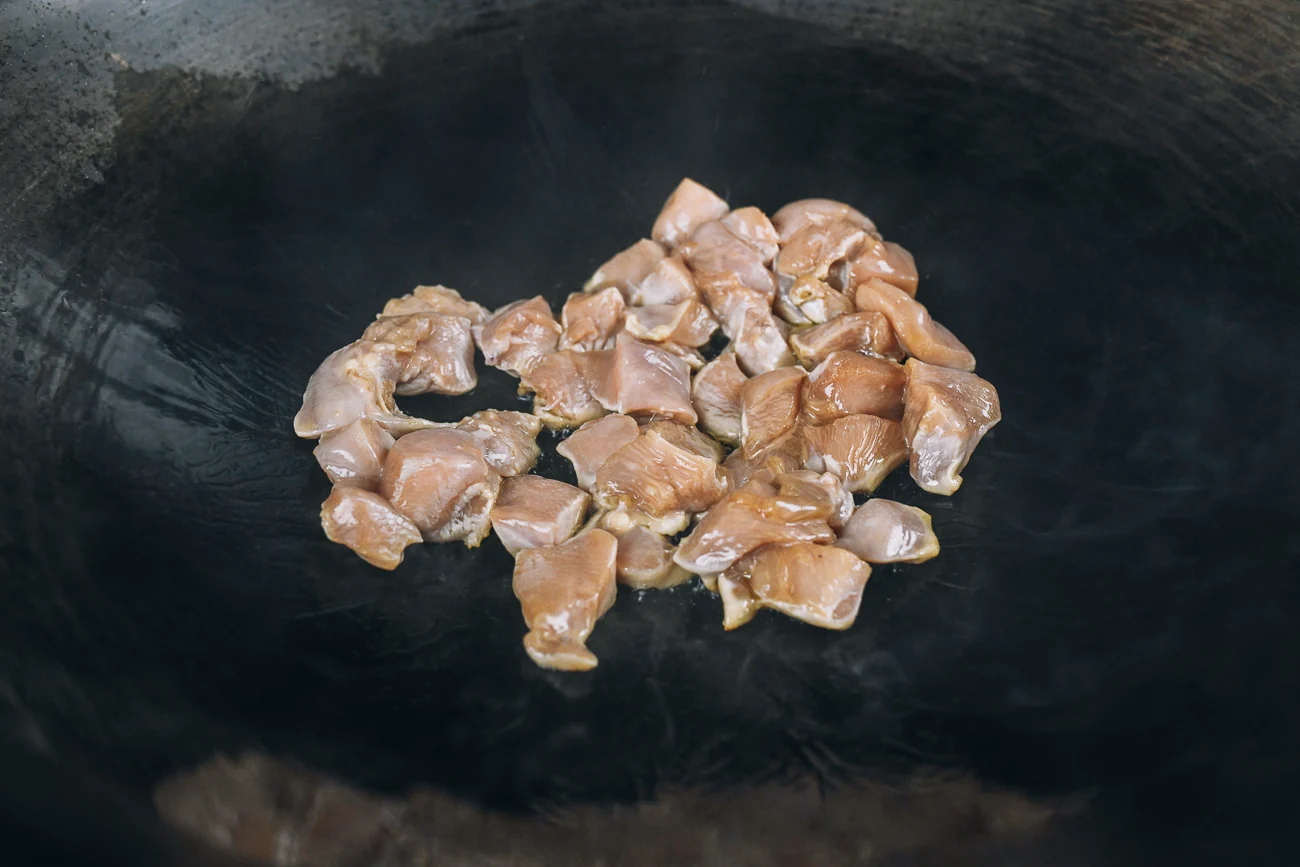 chicken cubes in wok
