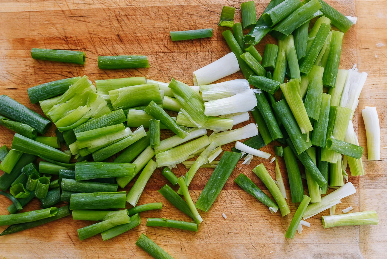 smashed scallions on cutting board