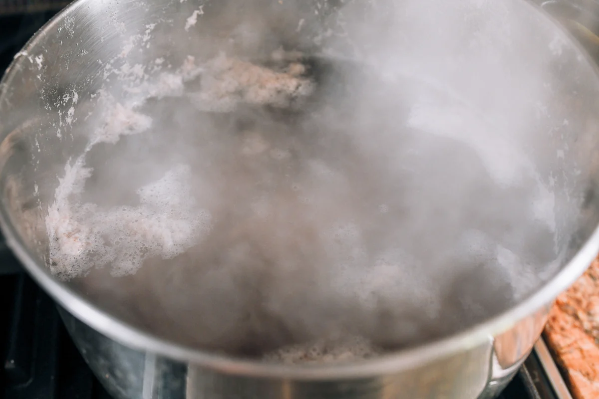 blanching pork bones in pot of water
