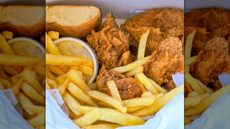 Close-up of basket of fried chicken, fries, and bread