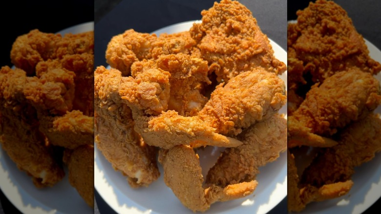 Pile of fried chicken on white plate