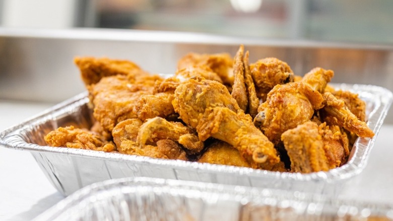 Large aluminum pan of fried chicken